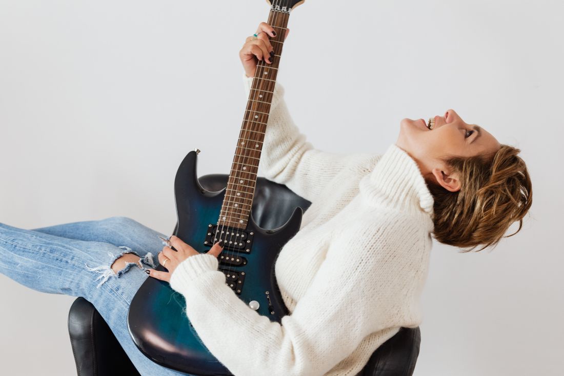 A young renter relaxed and happy at home in a bright apartment